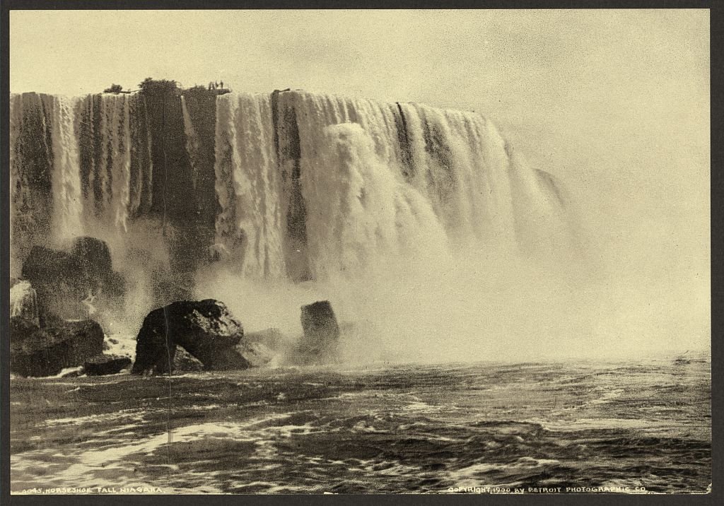Photochrom print of the American Falls at Niagara, with mist rising off the rocks below